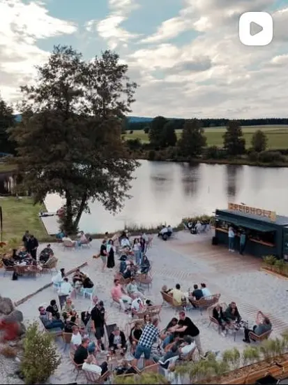 Instagram-Reel: Luftaufnahme der Treibholz Beachbar mit Gästen am Erlenweiher